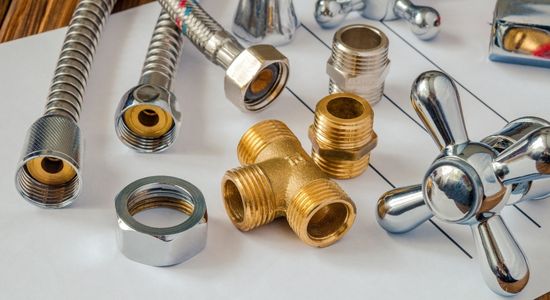 Assortment of gas fitting components and hot water system parts for Hydrofix Plumbing installations in Auckland